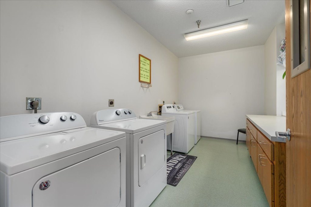 A laundry room with washers and dryers.