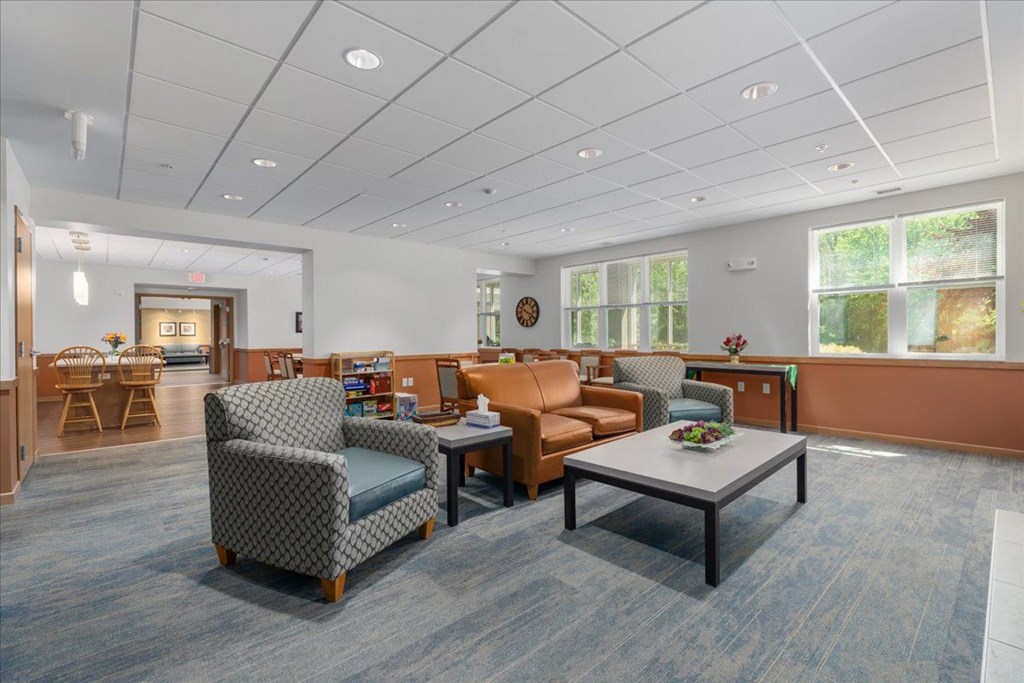 A spacious waiting room with comfortable seating and a coffee table.