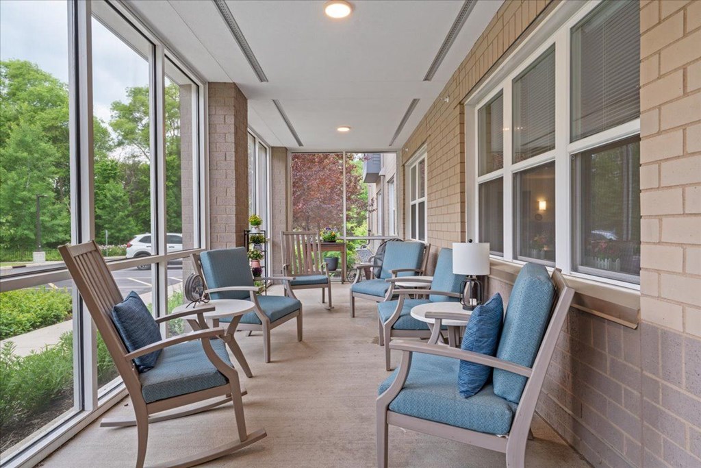 A row of chairs are lined up on a patio.