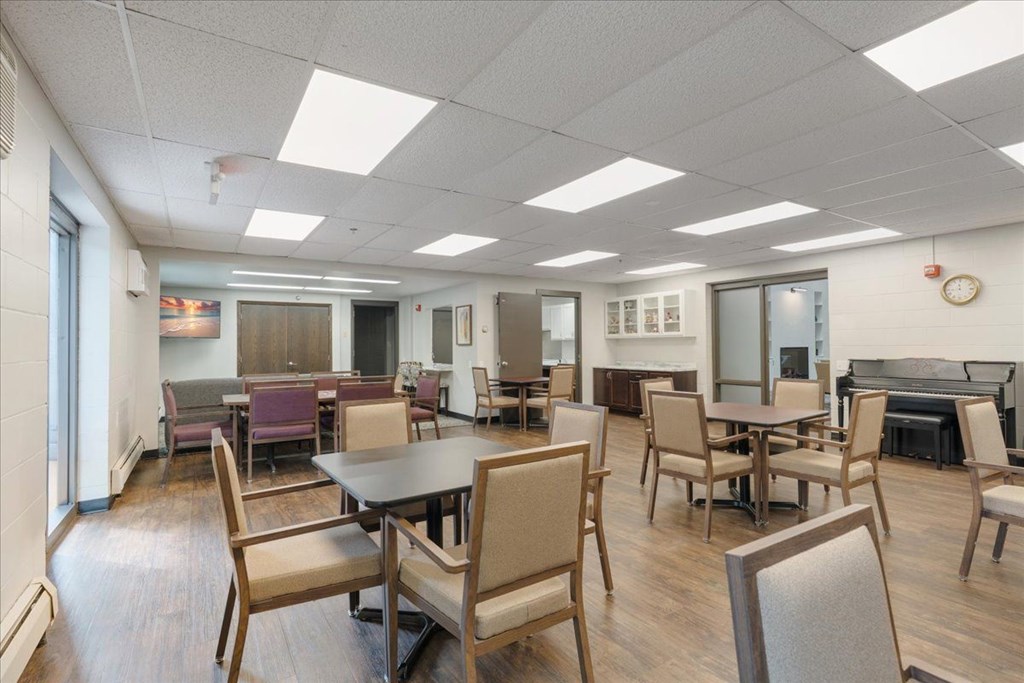 A conference room with a long table and chairs.