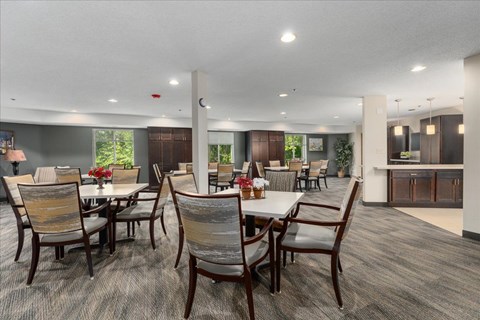A dining room with a table and chairs.