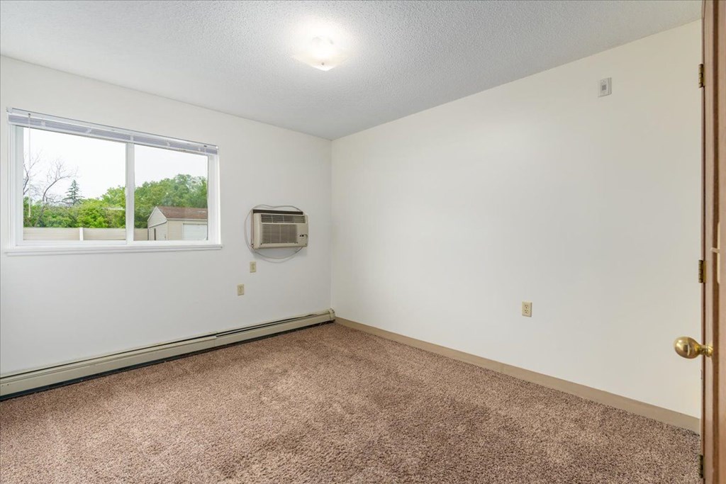 A room with a window and a door.