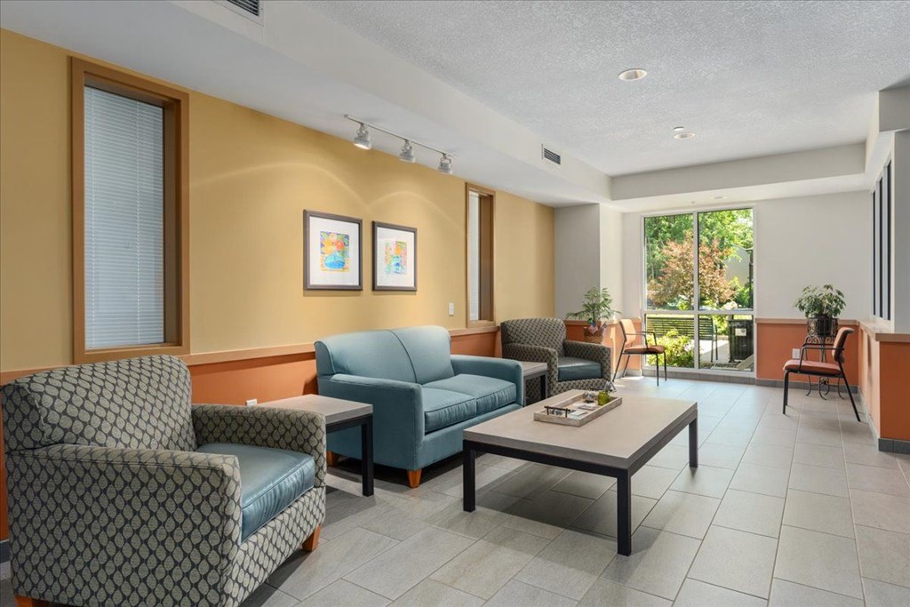 A living room with a sofa, armchairs, and a coffee table.