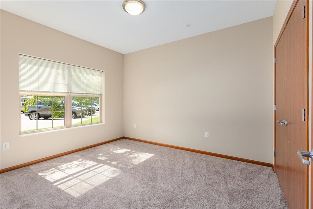 A room with a car parked outside the window.