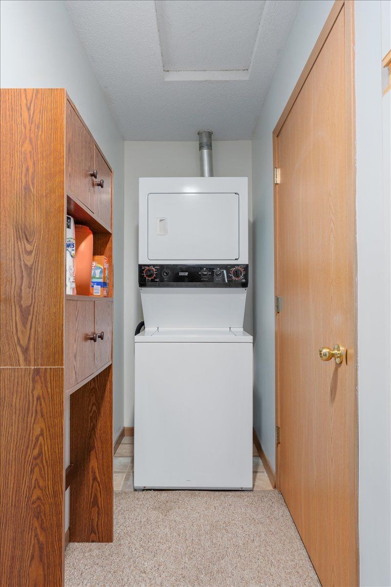 A small kitchen with a white dishwasher and a microwave above it.