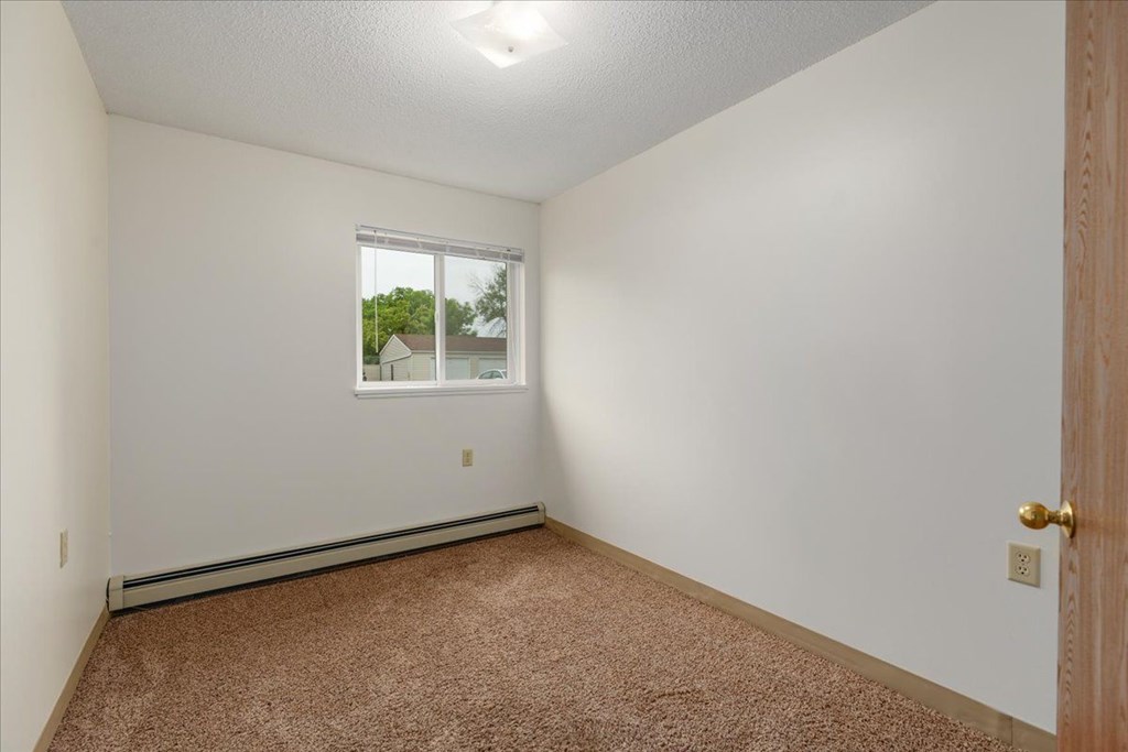 A room with a window and a door.