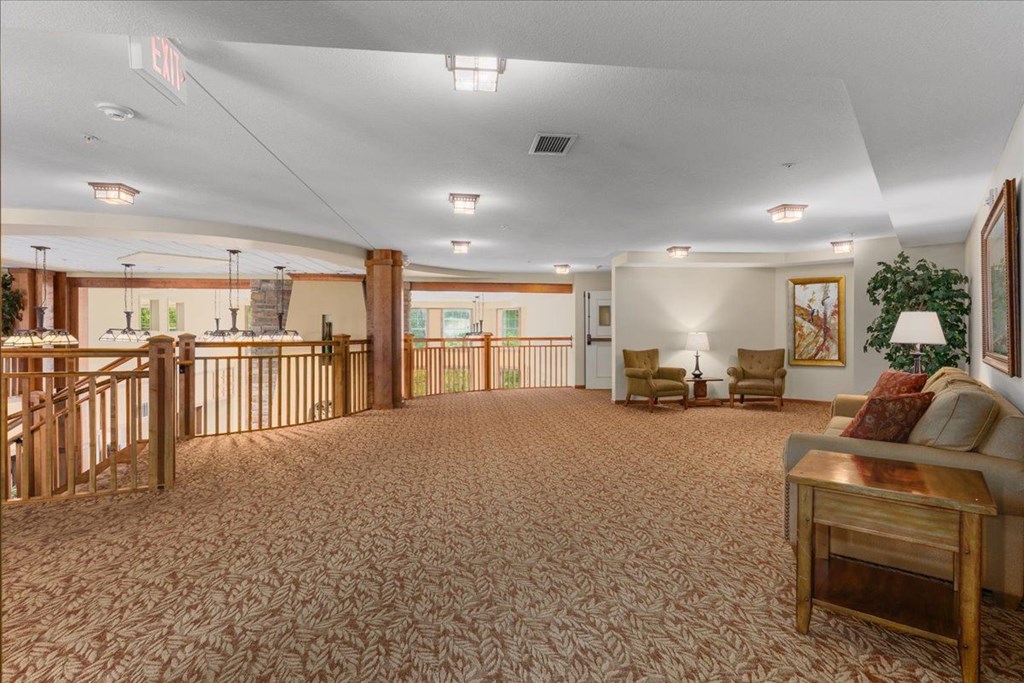 A large room with a carpeted floor and furniture.