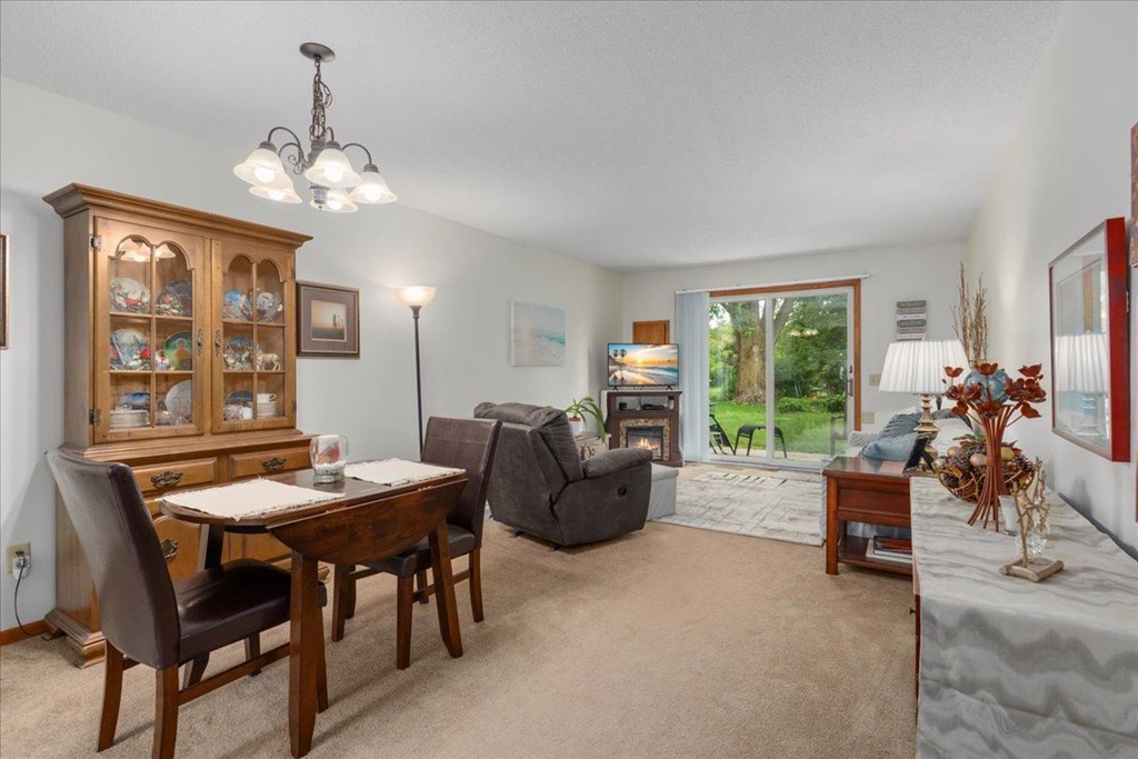 A dining room with a wooden table and chairs.