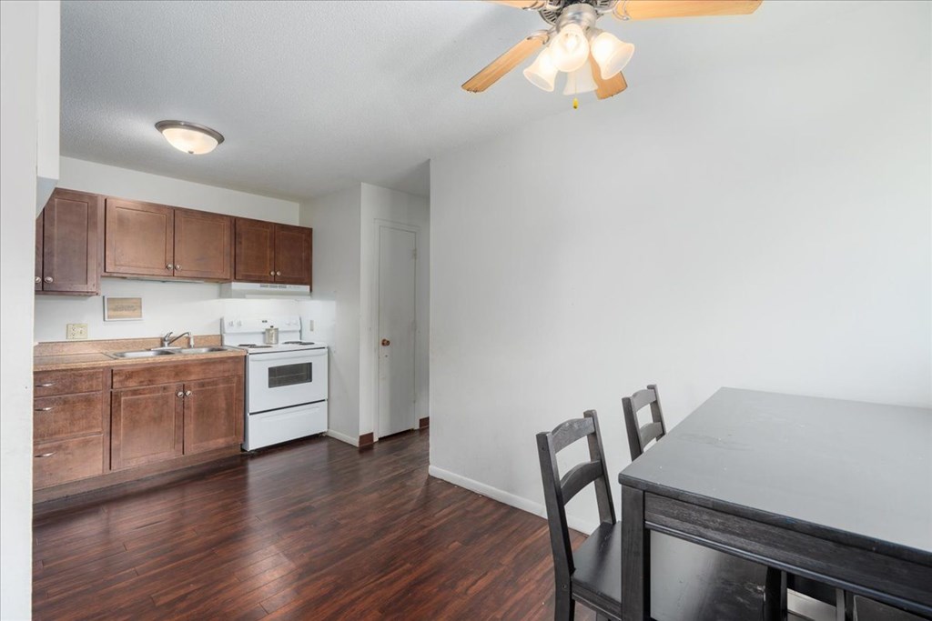 A kitchen with a table and chairs.