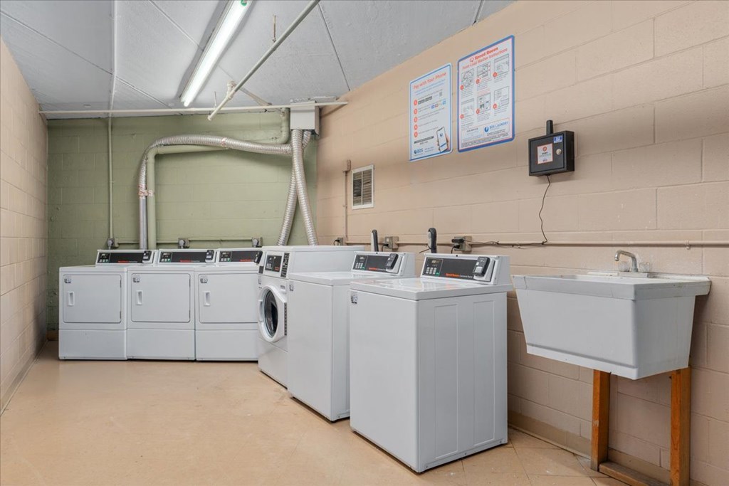 A laundry room with washers and dryers.