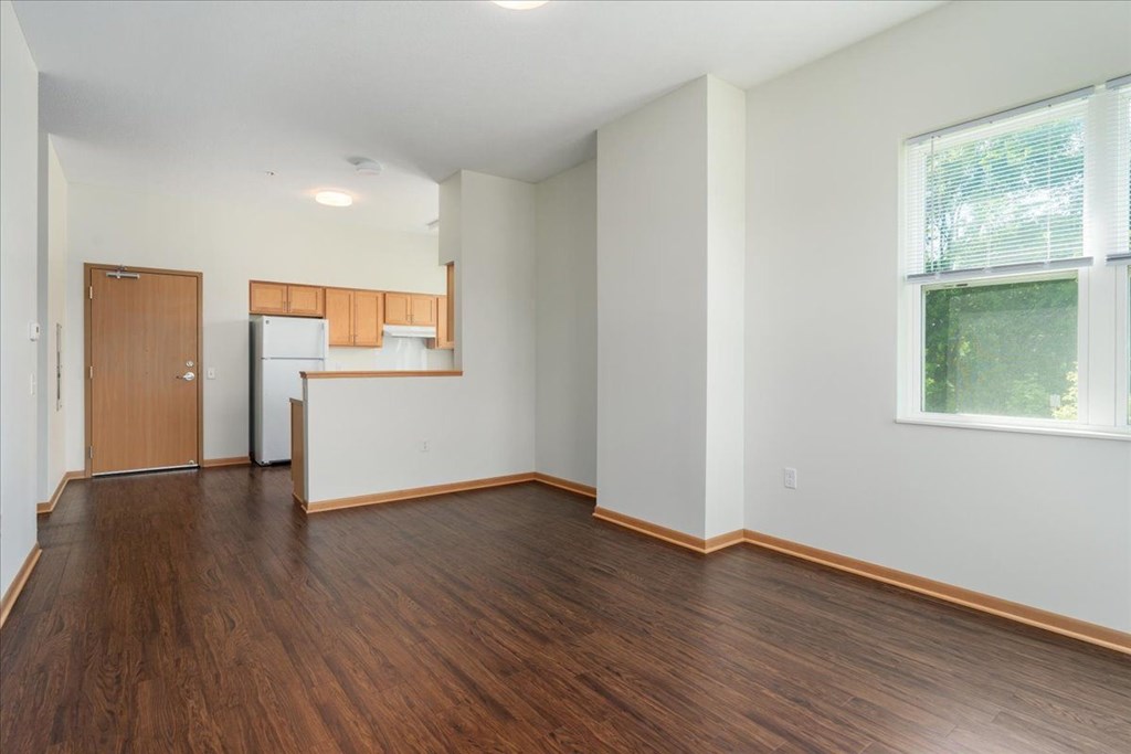 Empty room with wooden floors and white walls.