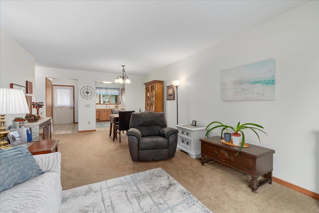 A living room with a grey couch and a brown coffee table.