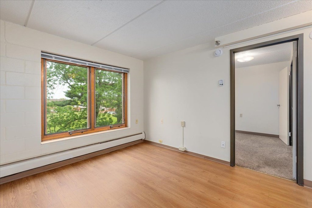 A room with a window and a door.