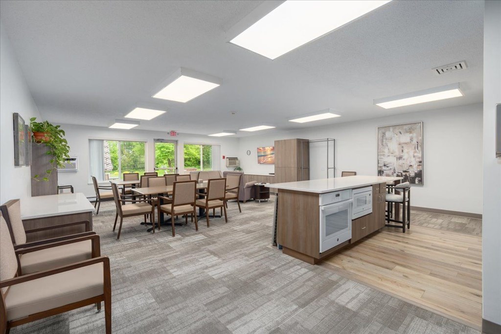 A modern kitchen with a dining table and chairs.