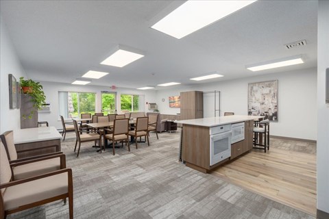 A modern kitchen with a dining table and chairs.