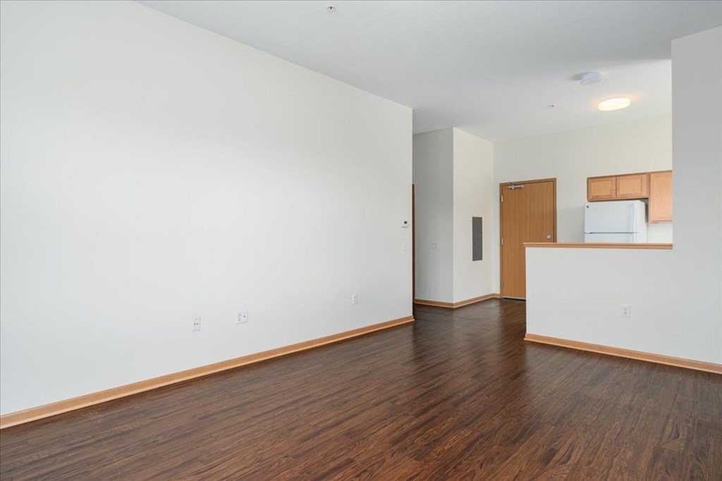 A room with wooden floors and white walls.