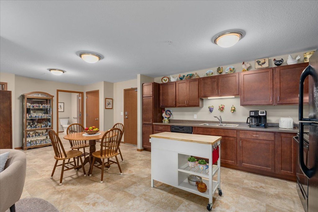 A kitchen with a table and chairs in the middle of the room.