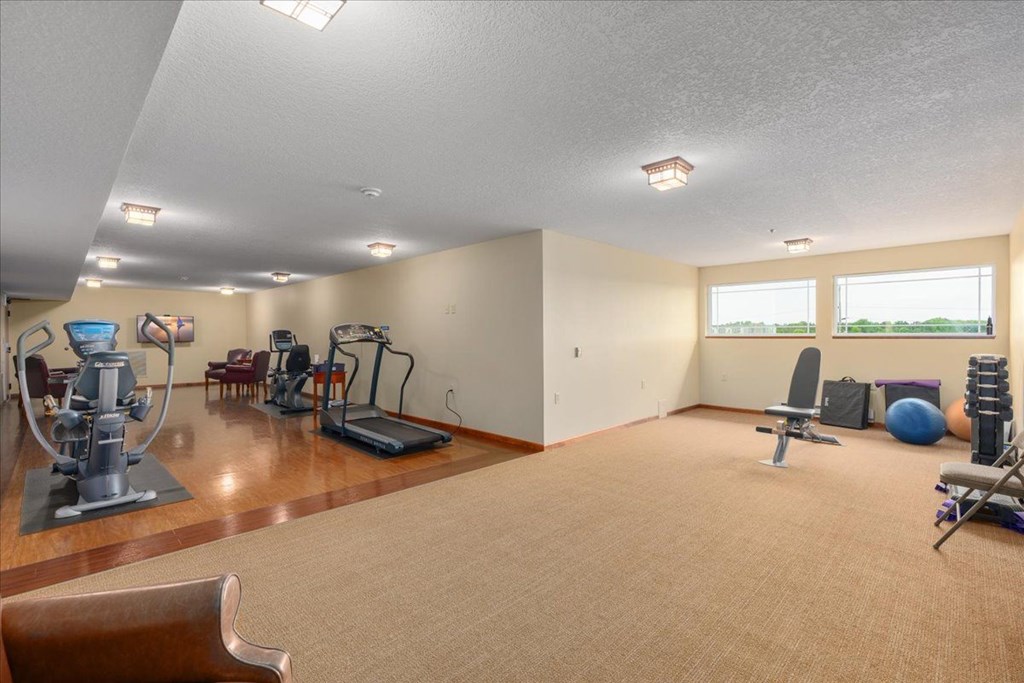 A spacious room with exercise equipment and a large window.