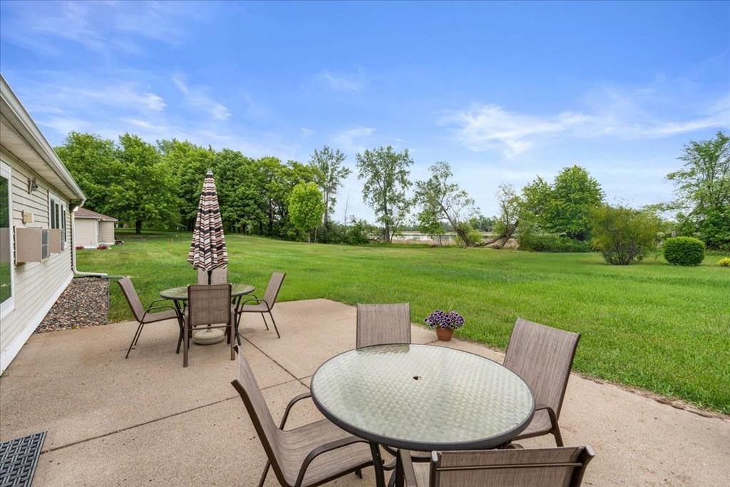 A patio with a table and chairs is set up outside.