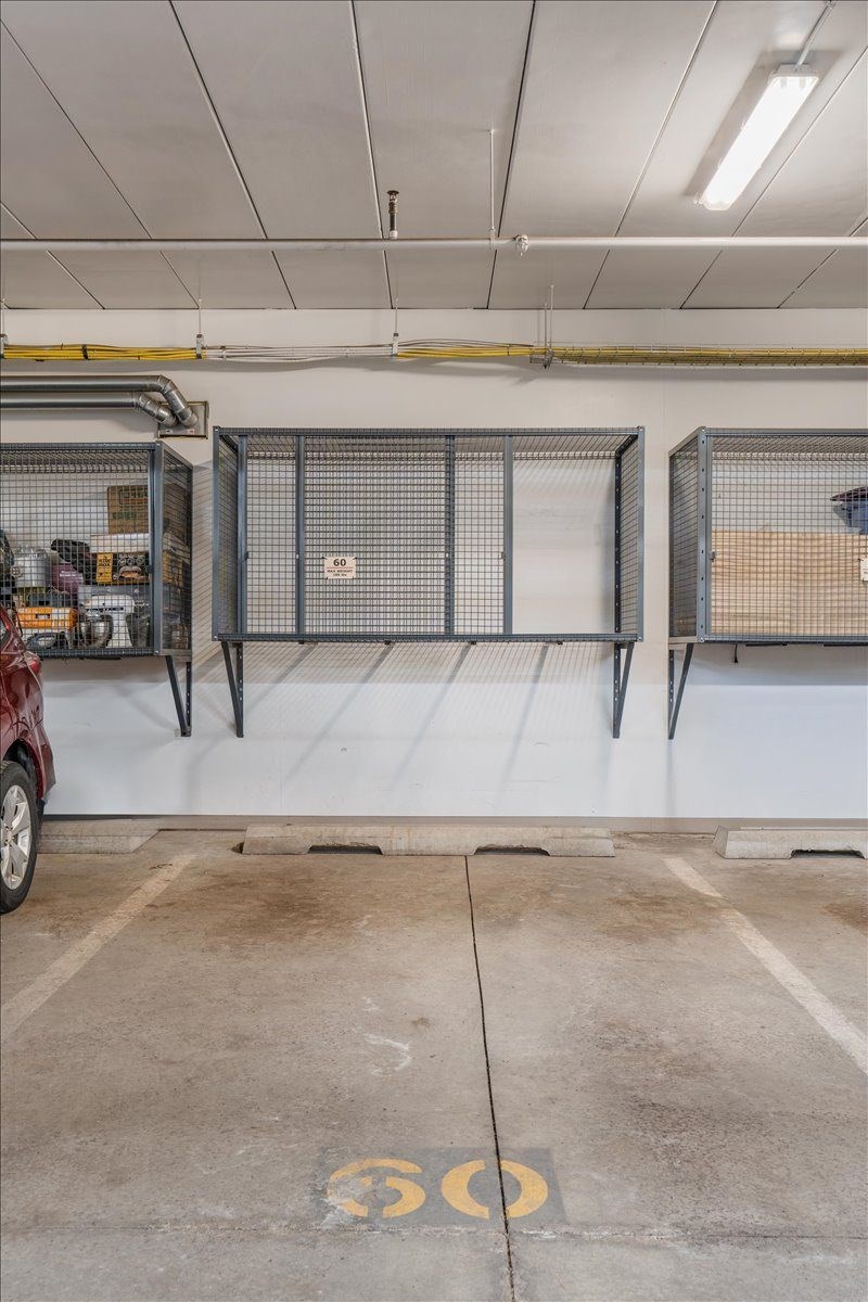 A parking garage with a red car and a sign that says 60.
