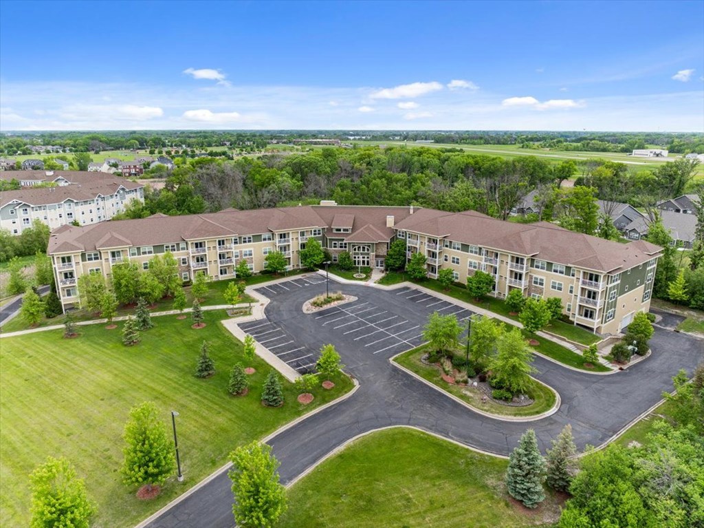 A large building with a parking lot in front of it.
