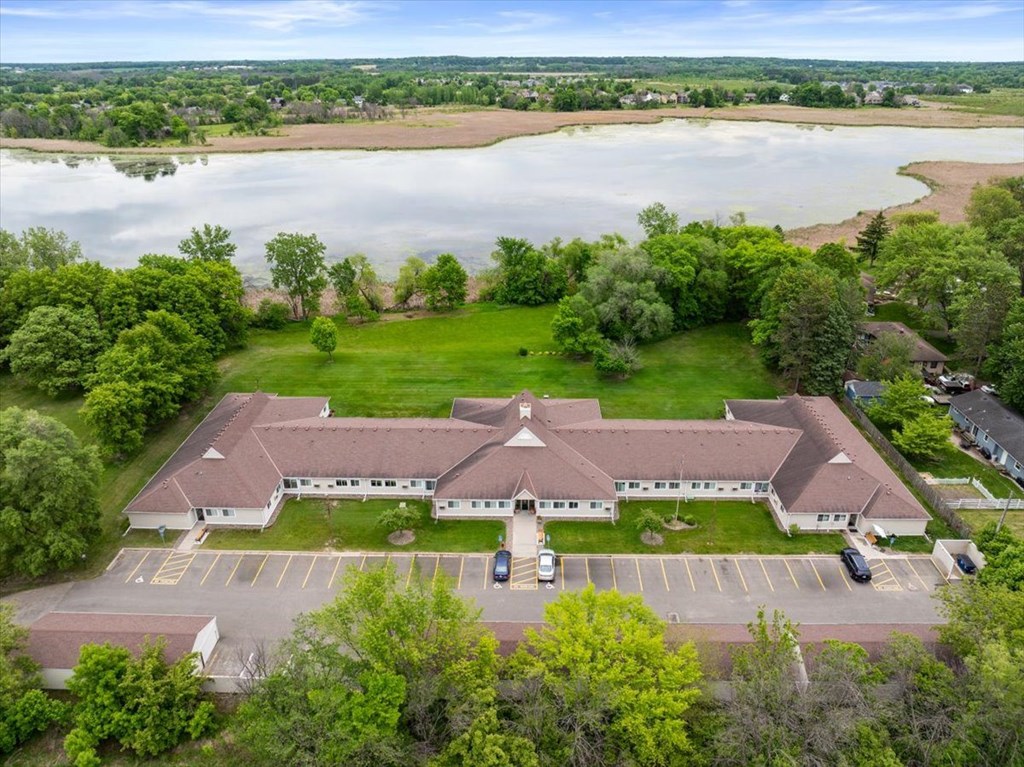 A large building with a parking lot in front of it.