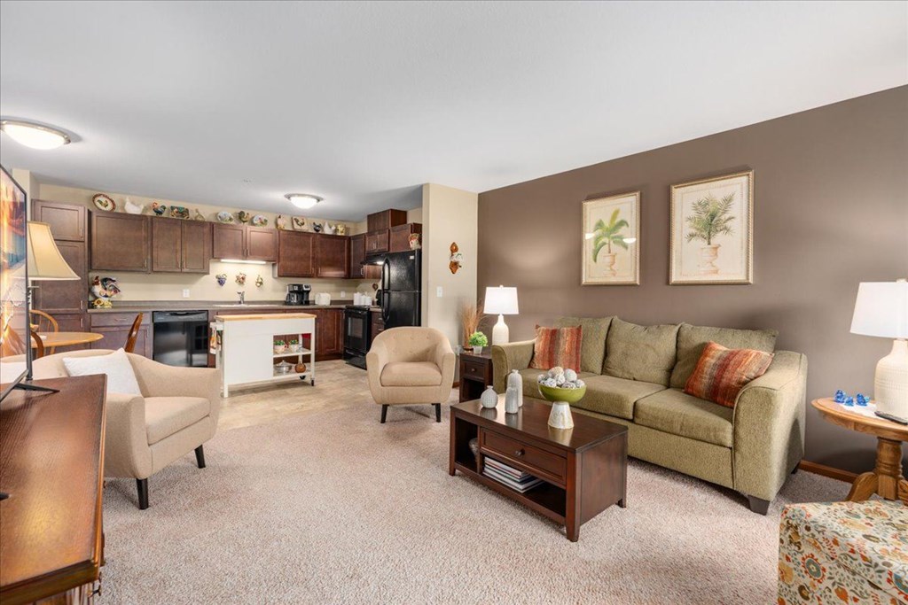 A living room with a couch, chairs, and a coffee table.