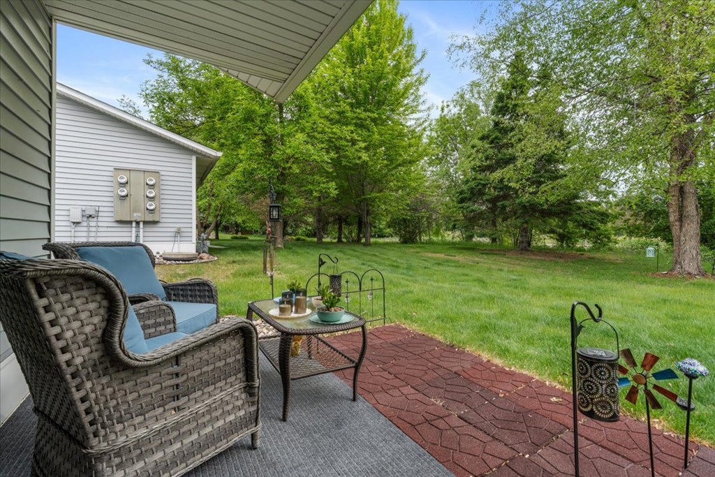 A patio with a chair and table is shown.