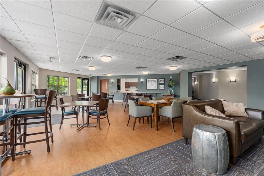 A living room with a dining table and chairs.