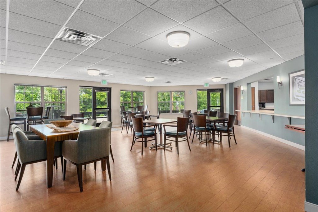 A room with a long table and chairs.