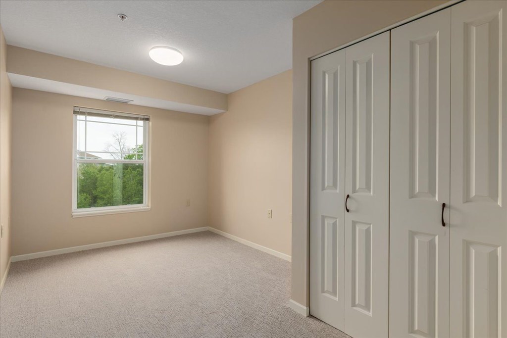 A room with a window and a door.