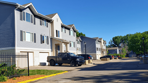 a truck parked in front of a row of houses