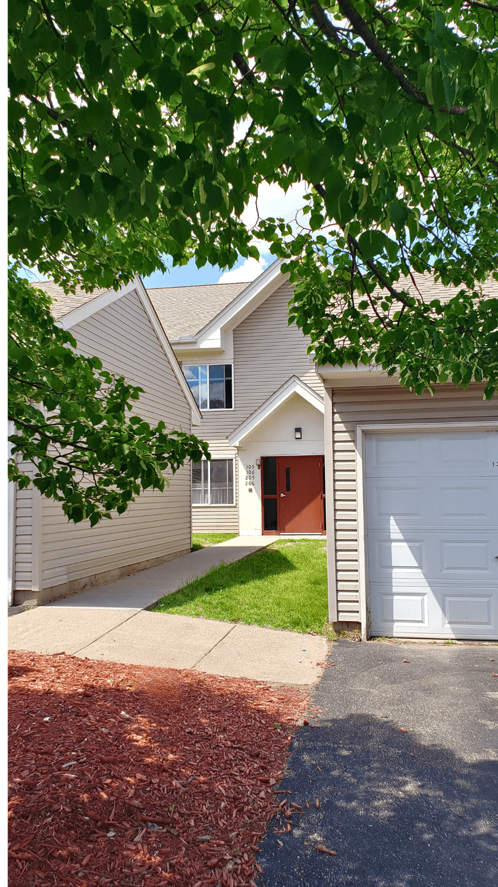 a white house with a driveway and a white garage door
