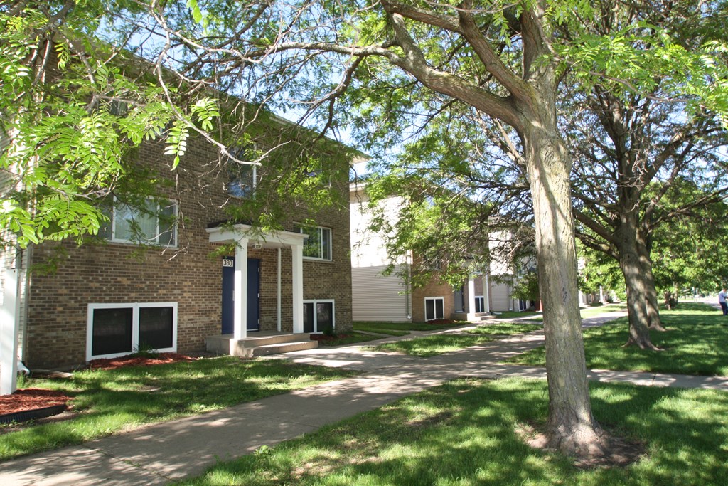 a brick building with trees in front of it
