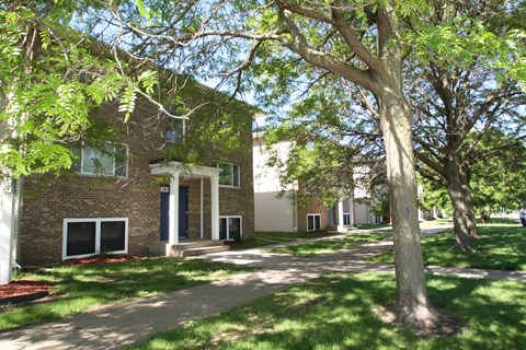 a brick building with trees in front of it