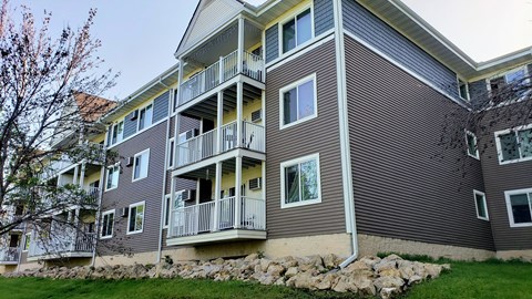 the exterior of an apartment building with balconies