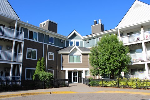 an apartment building with a street in front of it