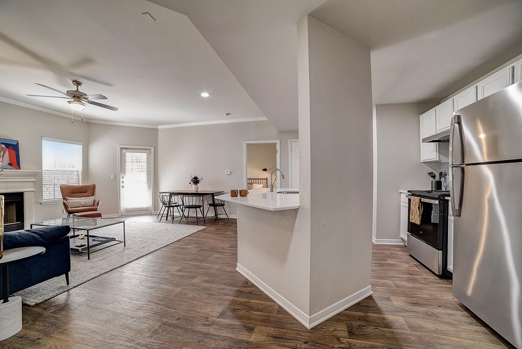 a renovated living room with a kitchen and a dining room