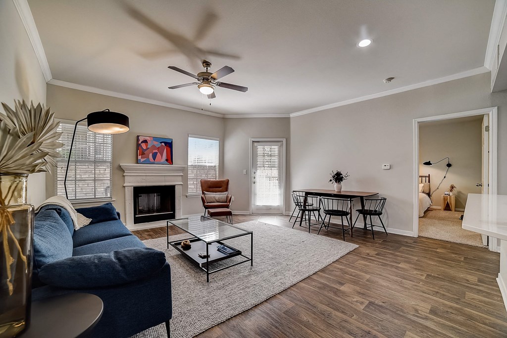a living room with a couch and a table and a ceiling fan