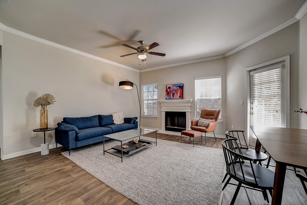 a living room with a couch and a ceiling fan