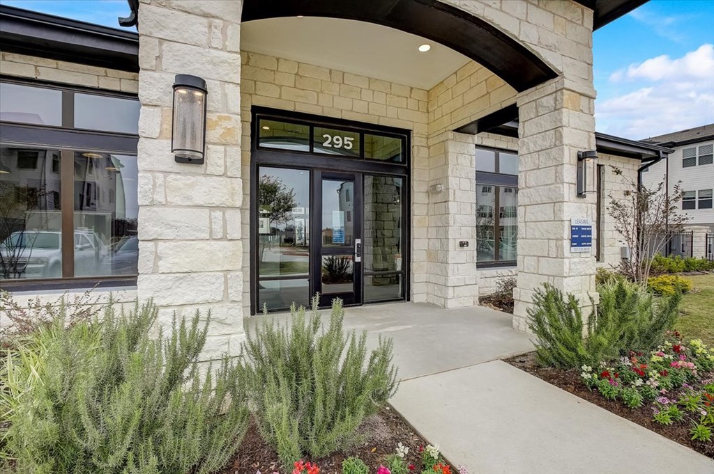 the front entrance of a building with glass doors