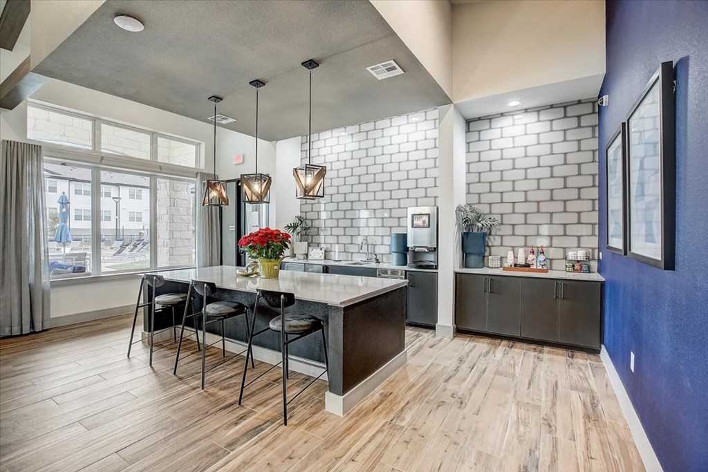 a dining room with a table and chairs and a kitchen