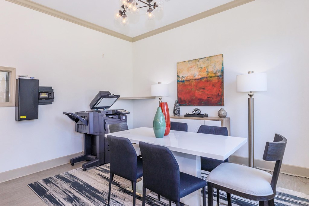 A dining room with a white table and chairs.