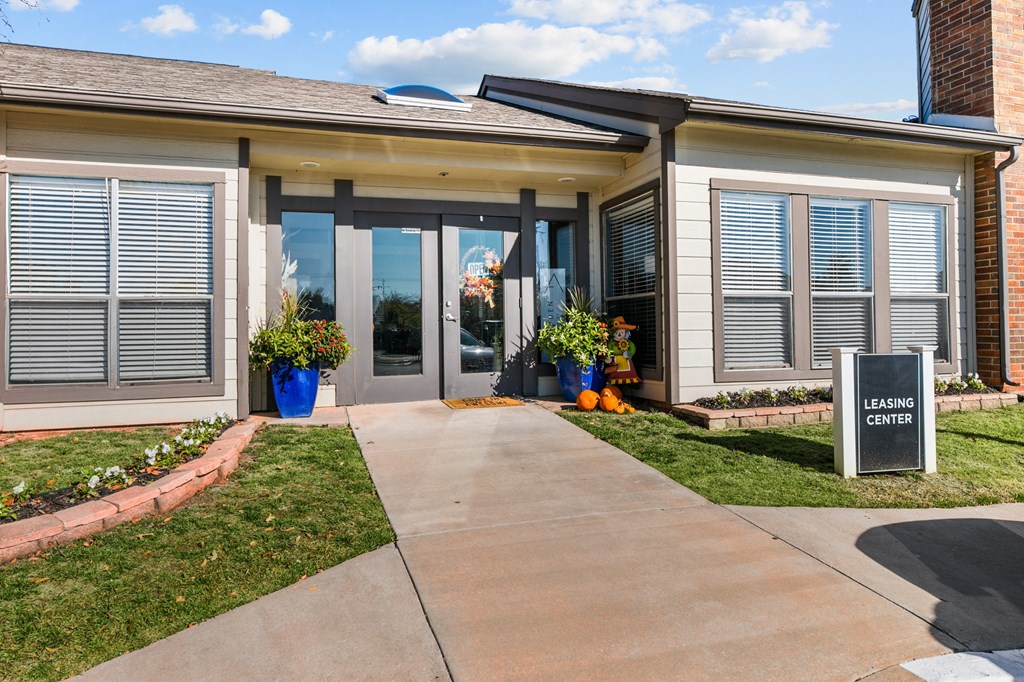 a house with a sidewalk and a sign in front of it
