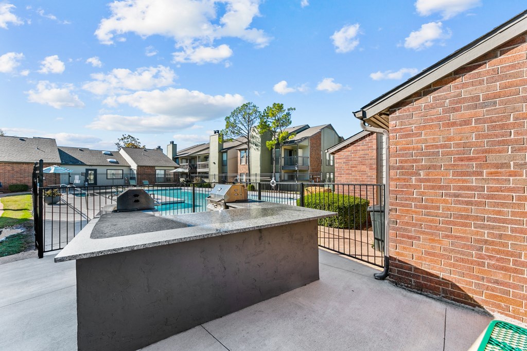 our apartments have a large patio with a pool and a brick wall