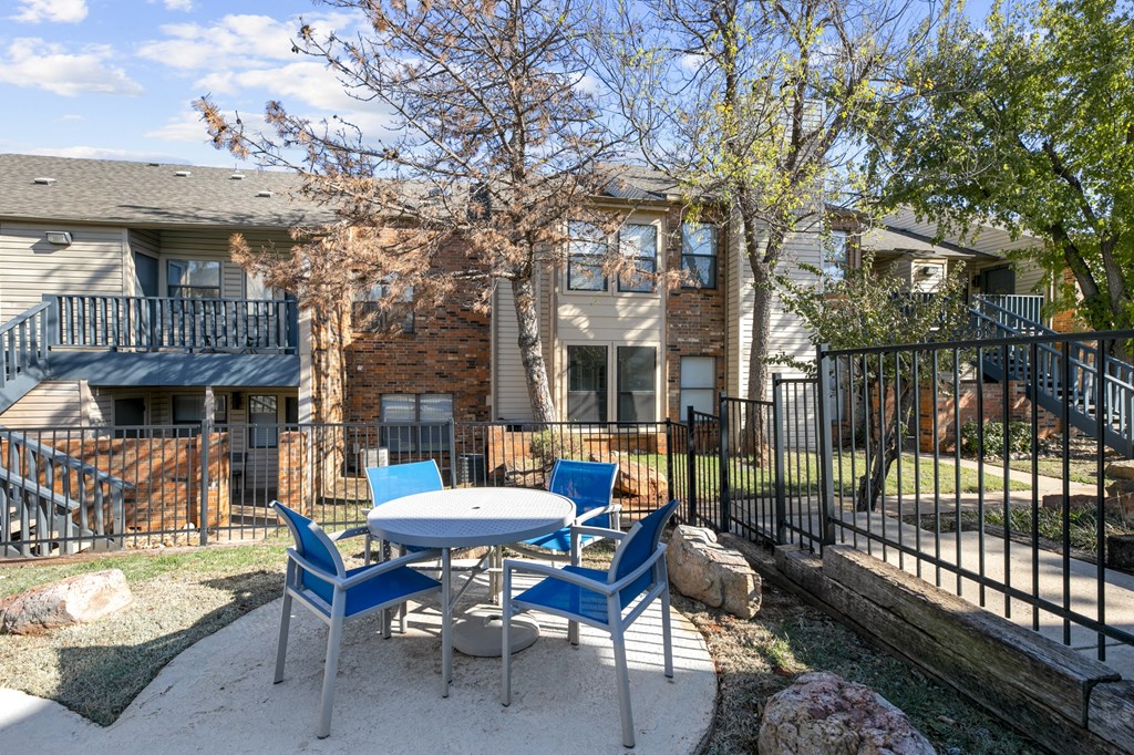 our apartments have a patio with a table and chairs