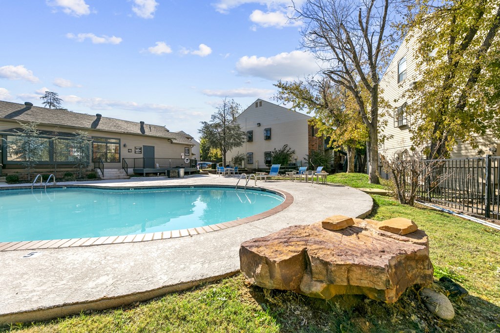 our apartments have a large pool and a backyard with a tree