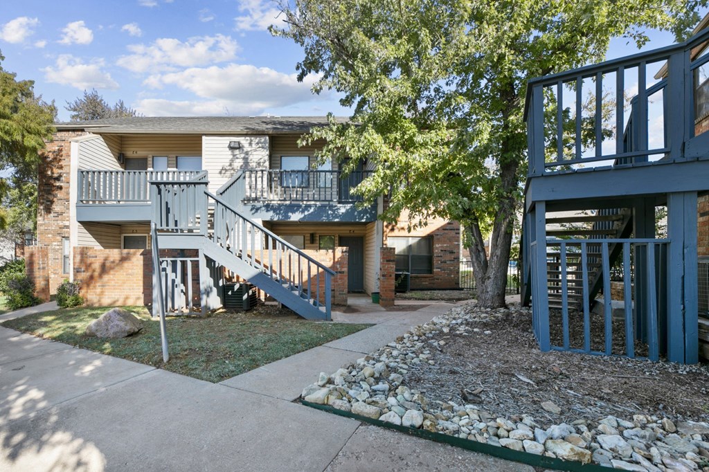 an exterior view of a house with stairs and a sidewalk