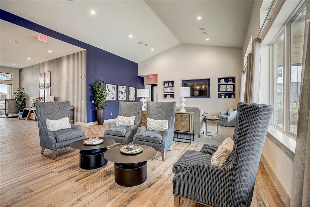 a living room with chairs and a table