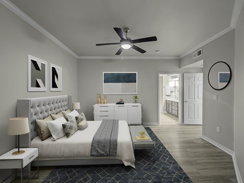 Bedroom with crown molding, ceiling fan, en suite bathroom entry, and wood-style flooring.